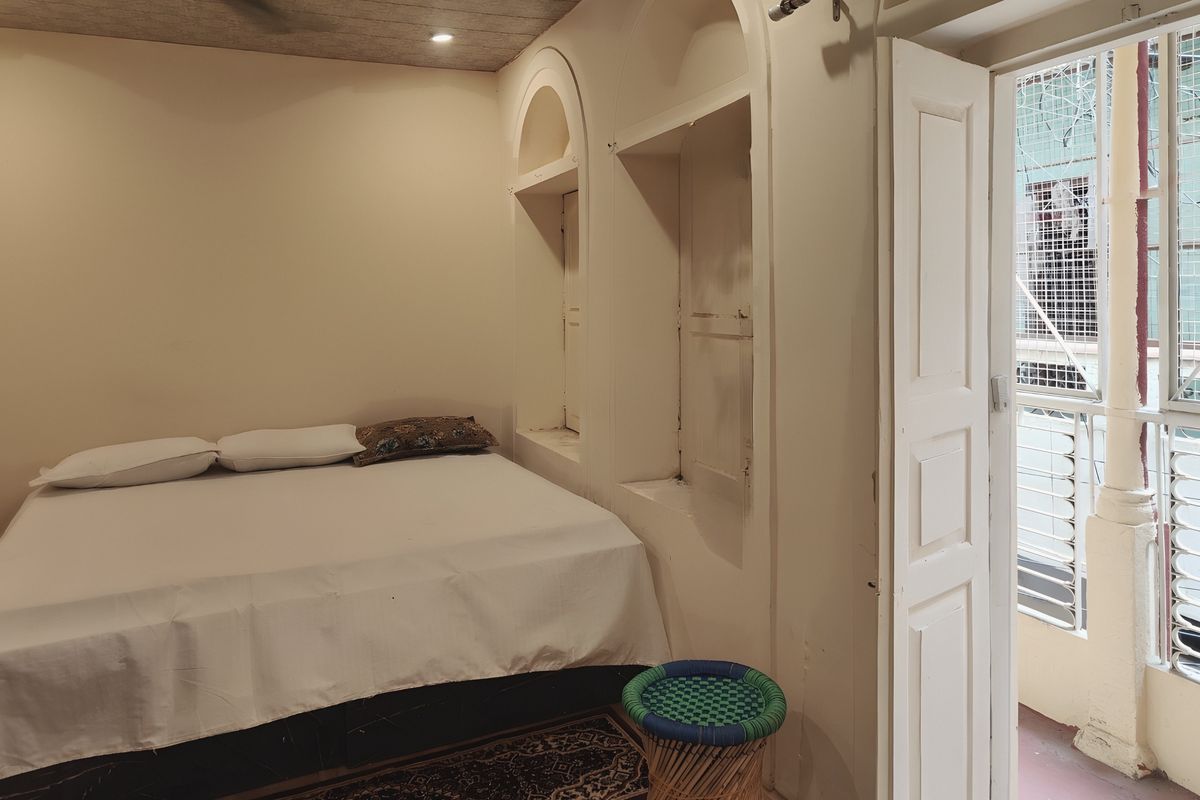A heritage room with its panelled door open onto a small balcony